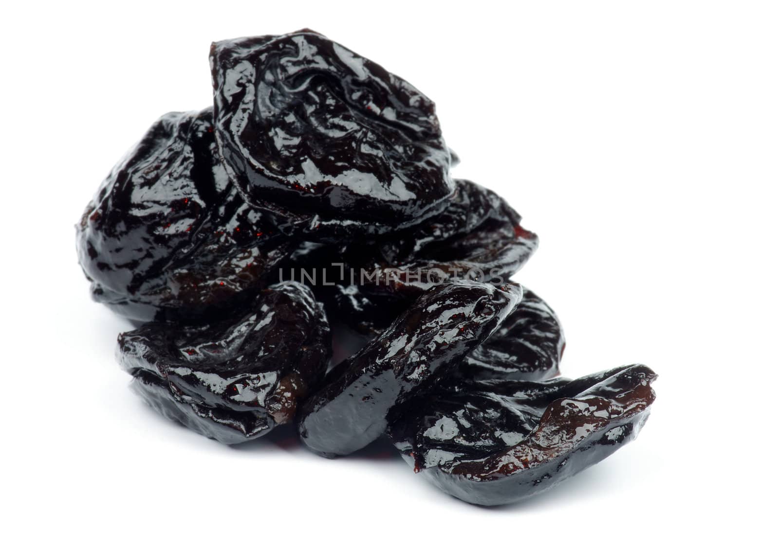 Heap of Succulent Dried Prunes isolated on white background