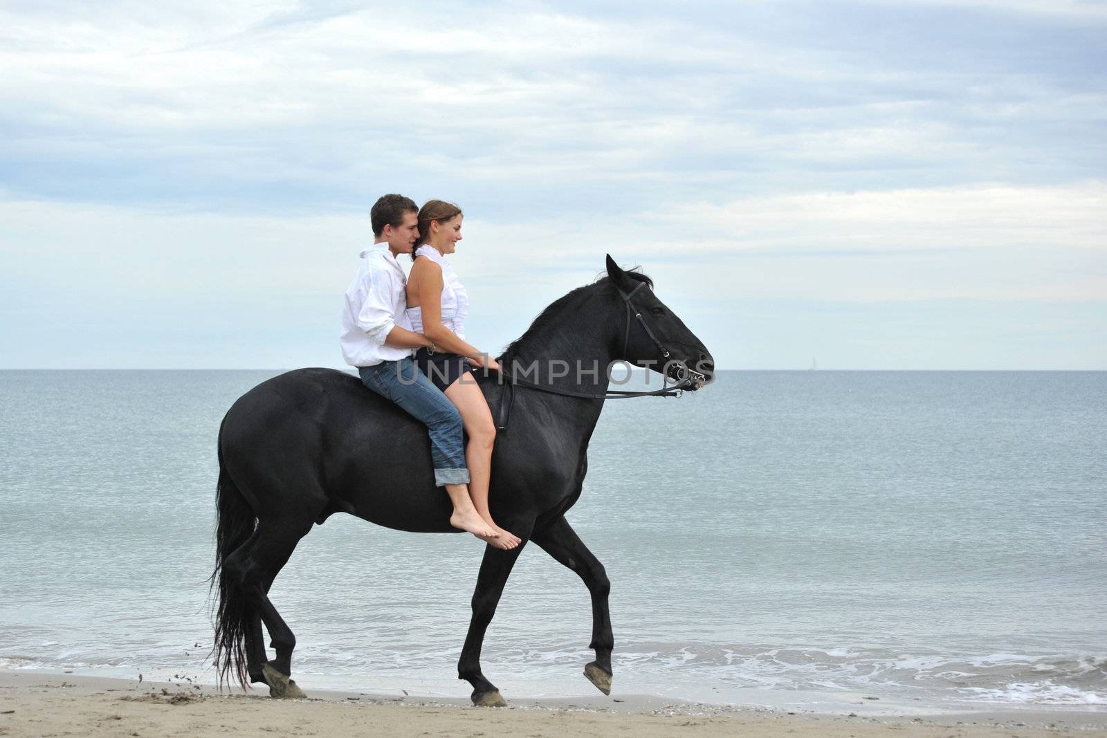 couple and  horse on the beach by cynoclub