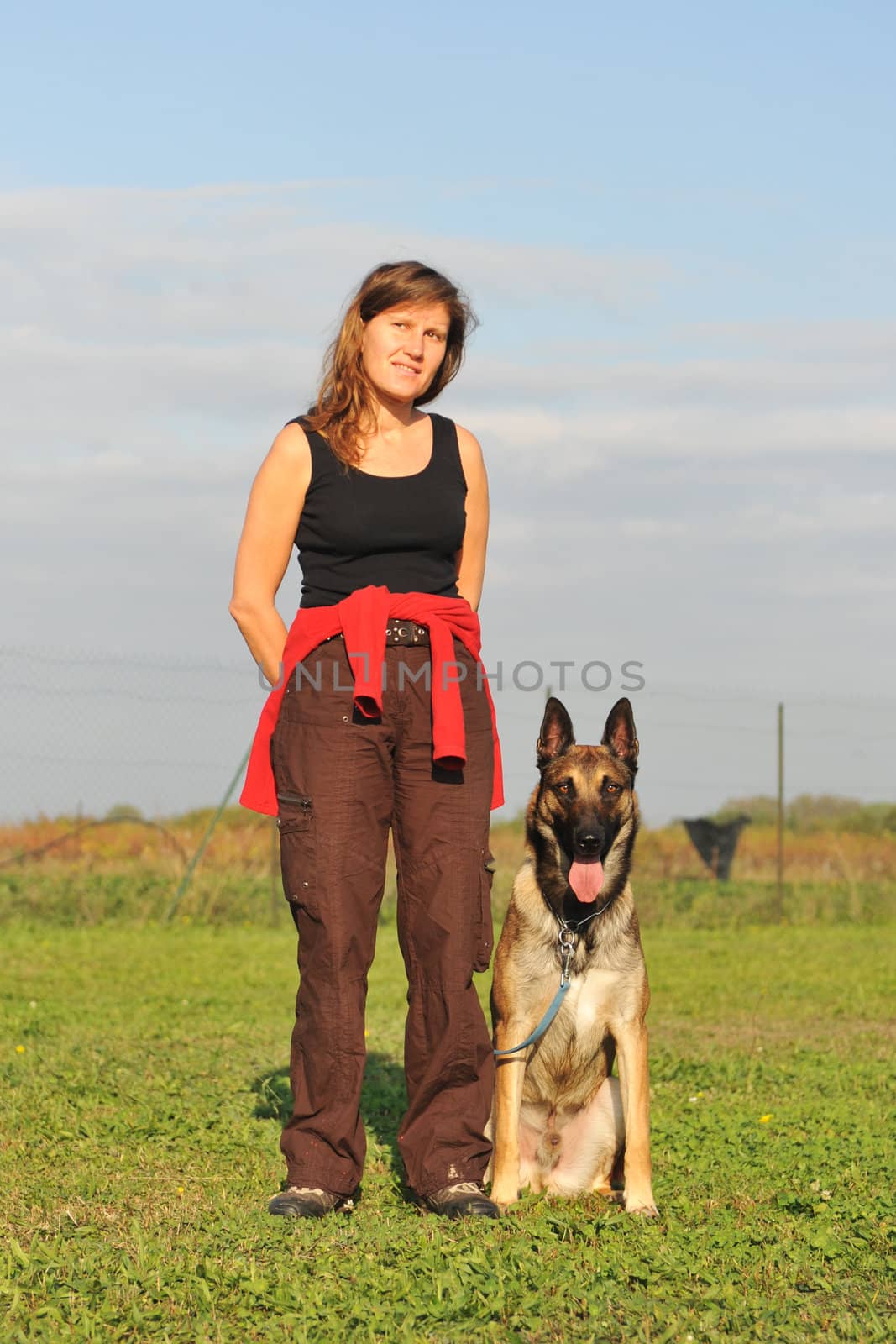 young woman and her purebred belgian sheepdog malinois