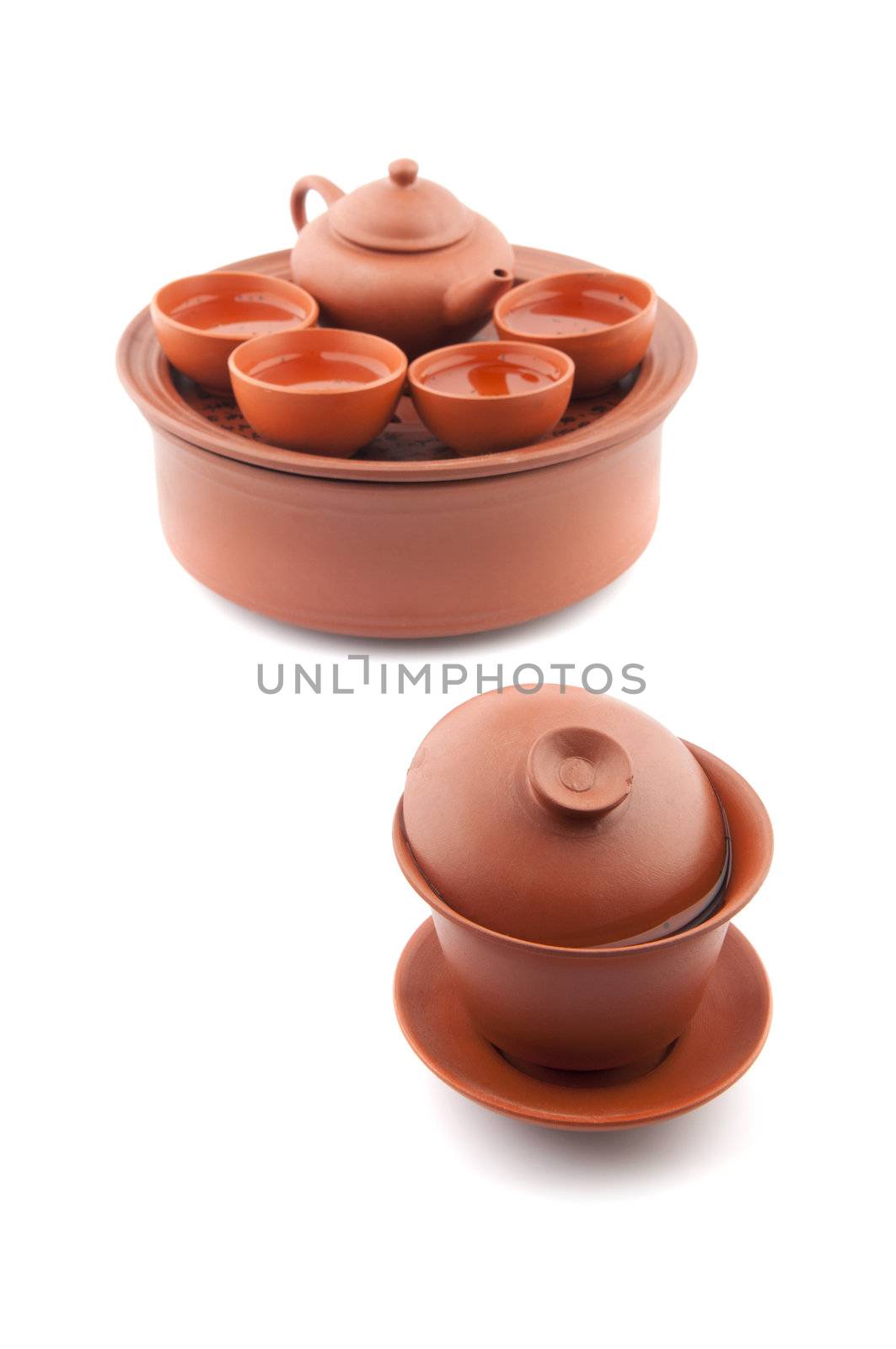 Chinese ceramic tea set and cups on white background.