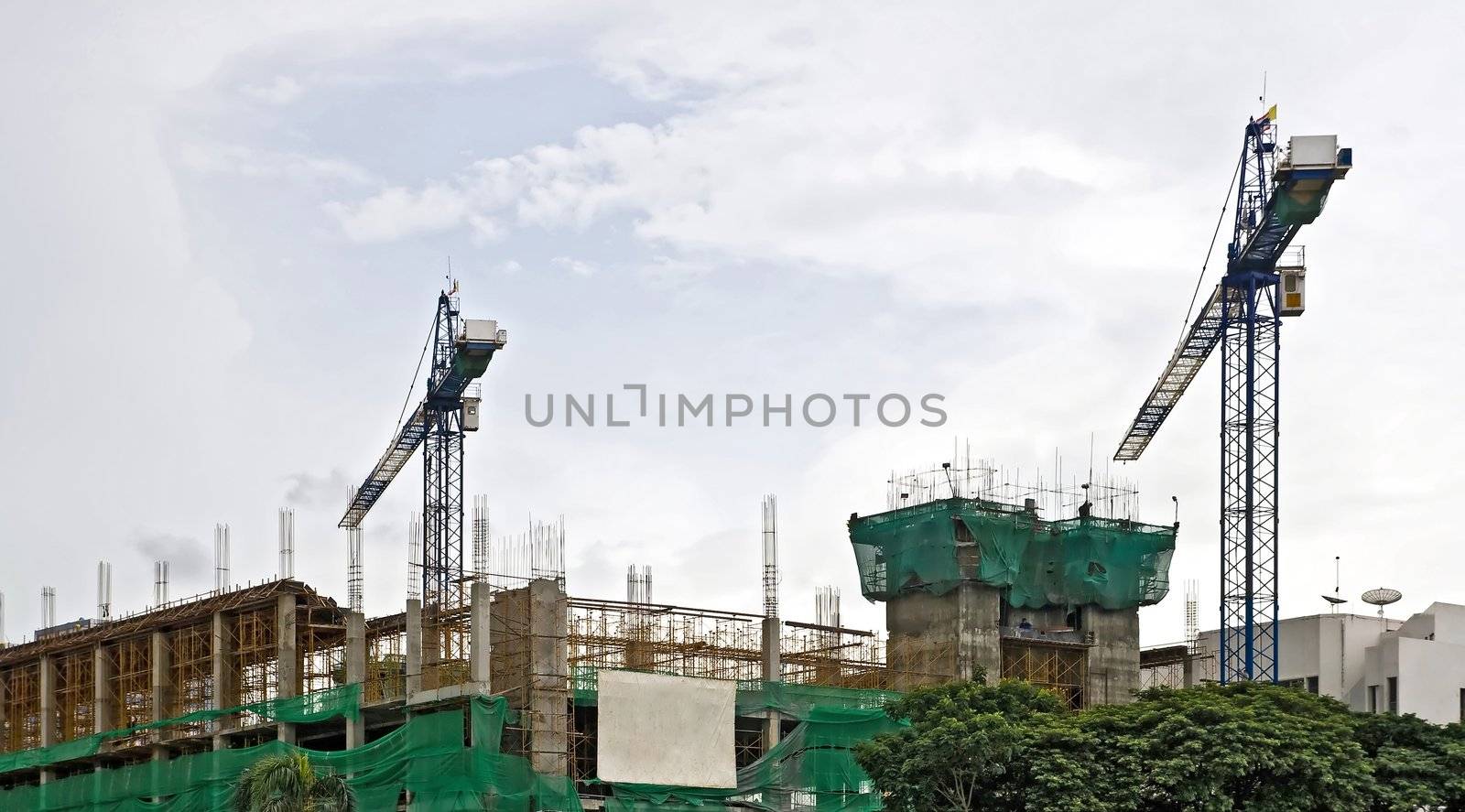 Sport Arena Building Under Construction with two Cranes