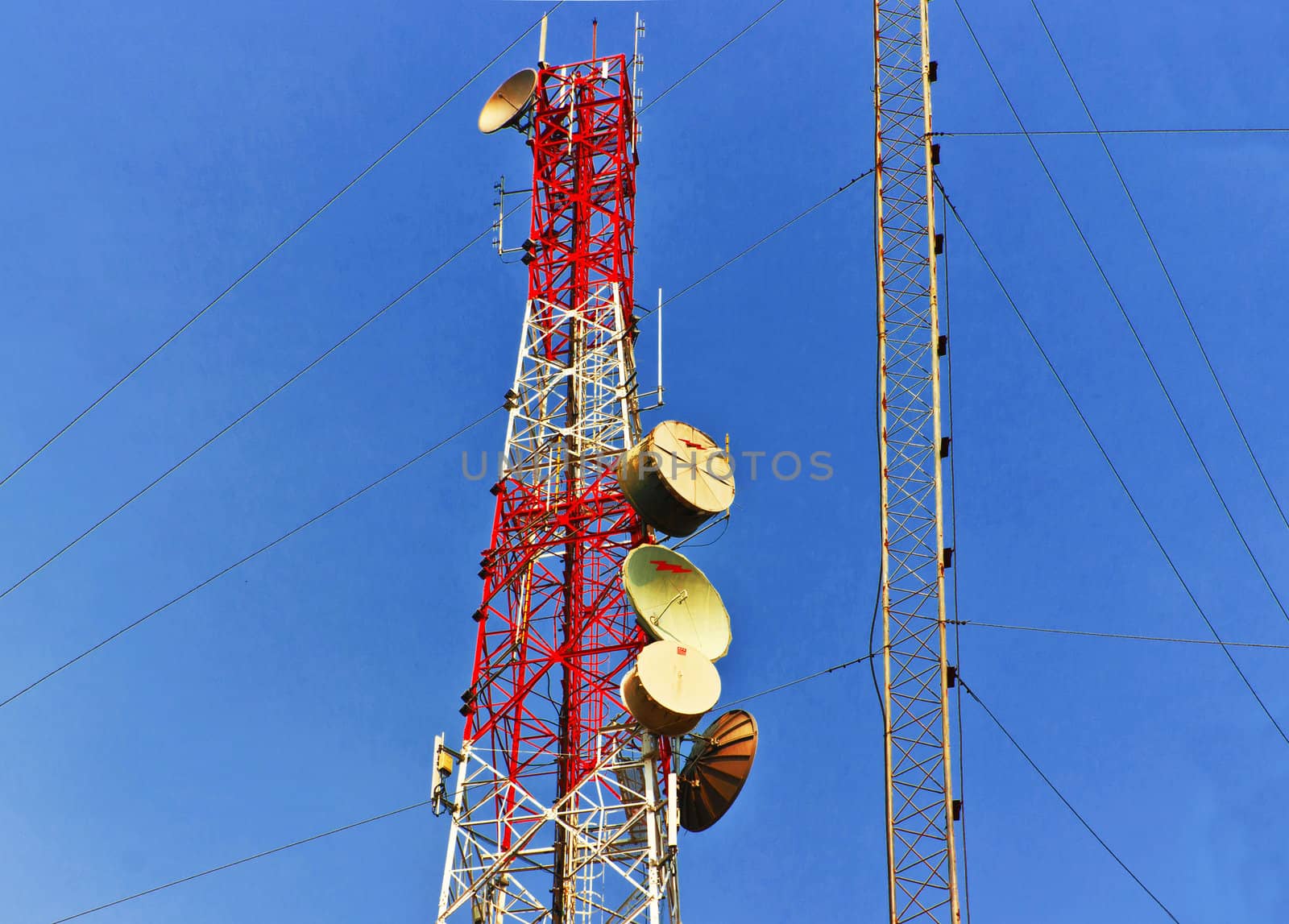 low angle view of  telecommunications towers against the sky by sutipp11