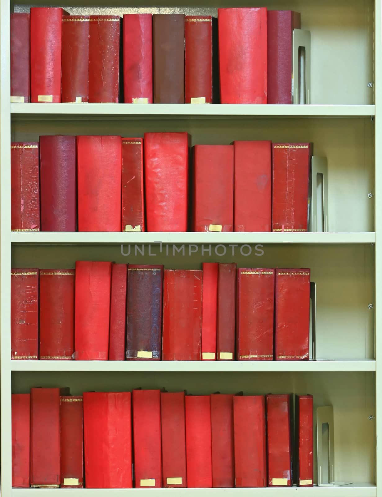 red old hardcover books on bookshelf