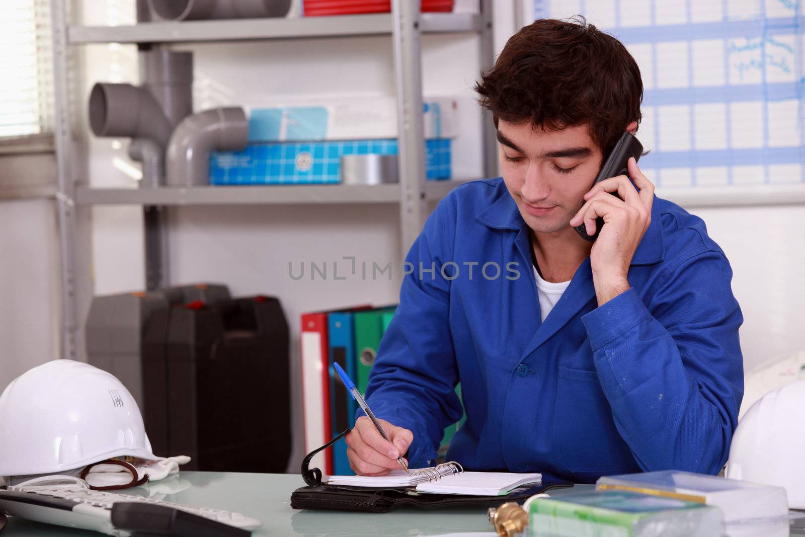 Construction worker arranging an appointment by phovoir
