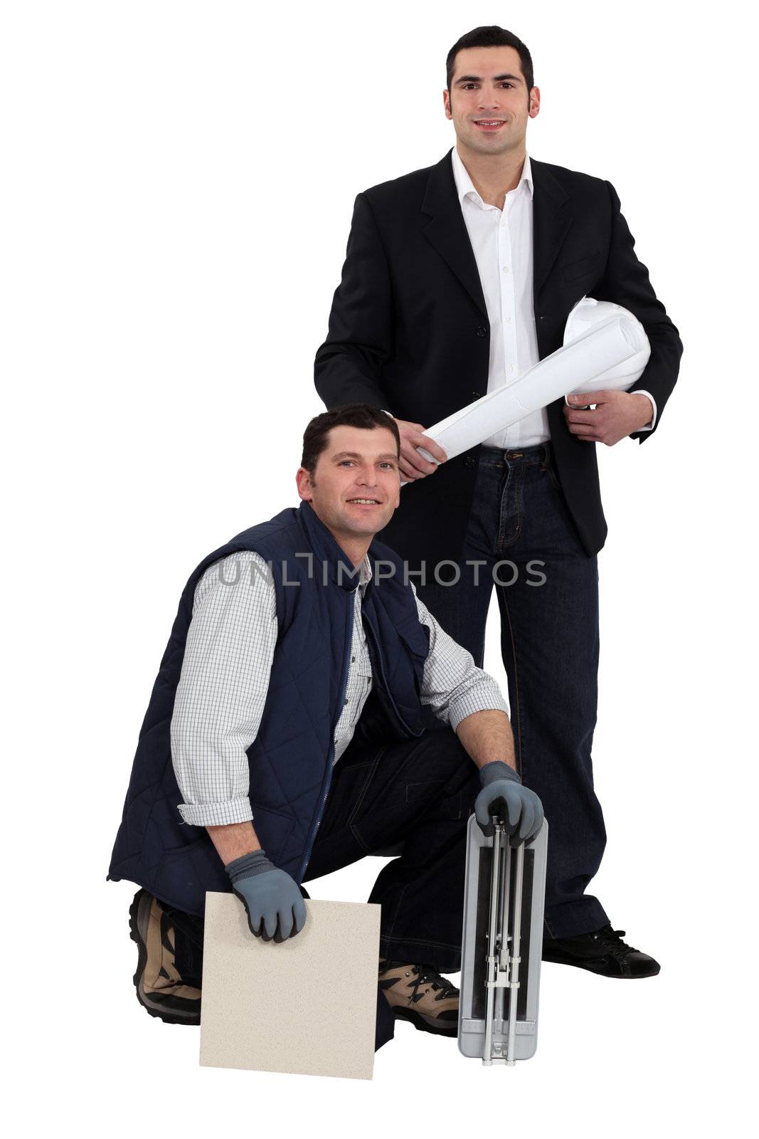 Portrait of an engineer and a workman holding a tile and a ceramic tile cutter by phovoir