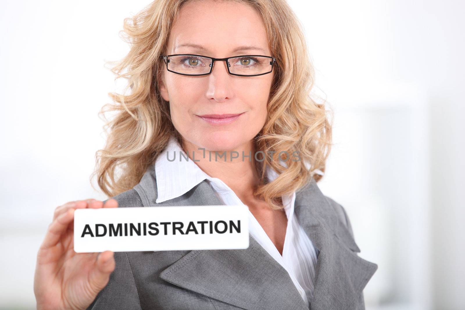 Blond office worker holding administrator badge