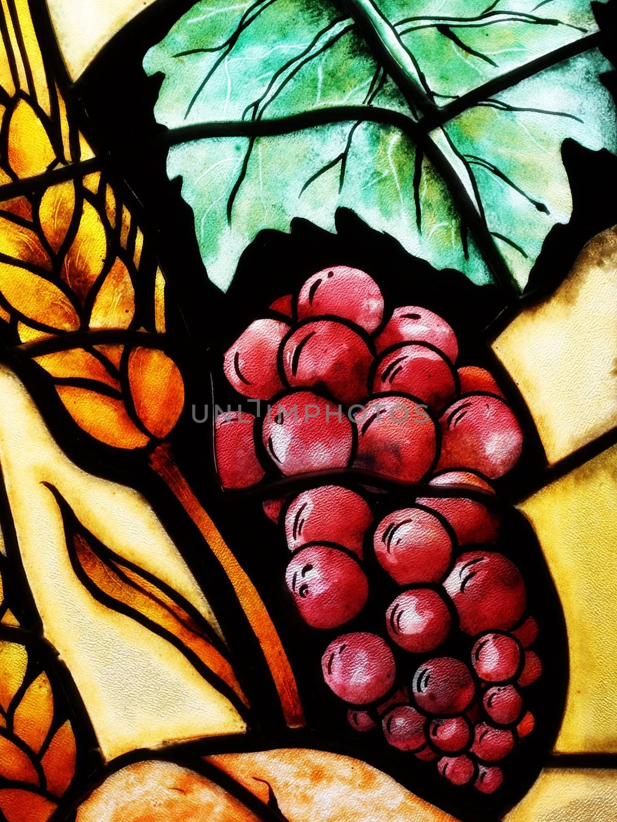 Detail of a grapes glass in church