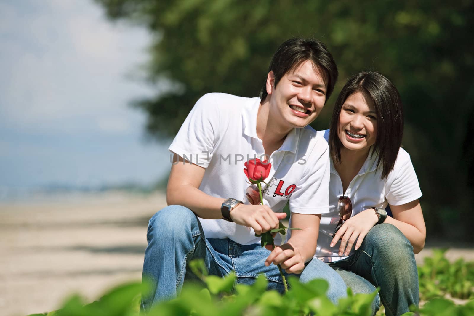 boy giving beautiful rose to his pretty girlfriend