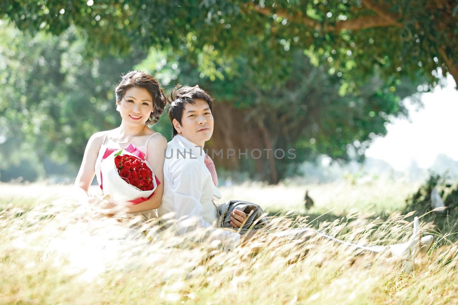 couples outdoors on windy grass