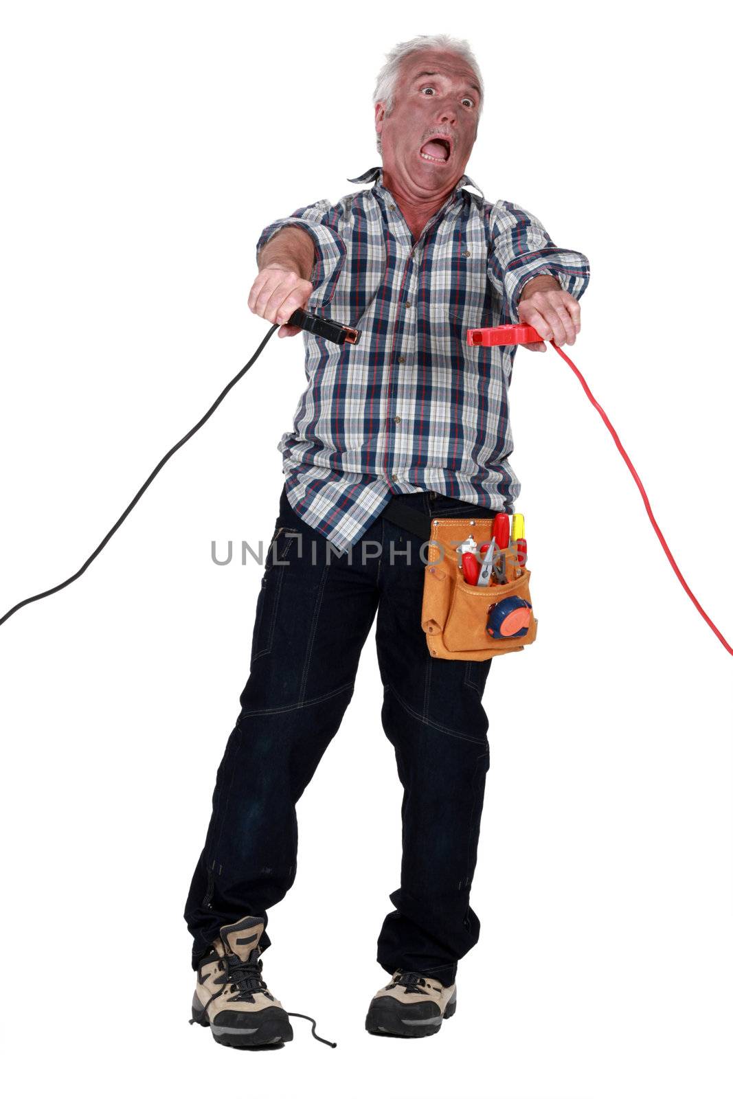 Man getting an electric shock from jump leads by phovoir