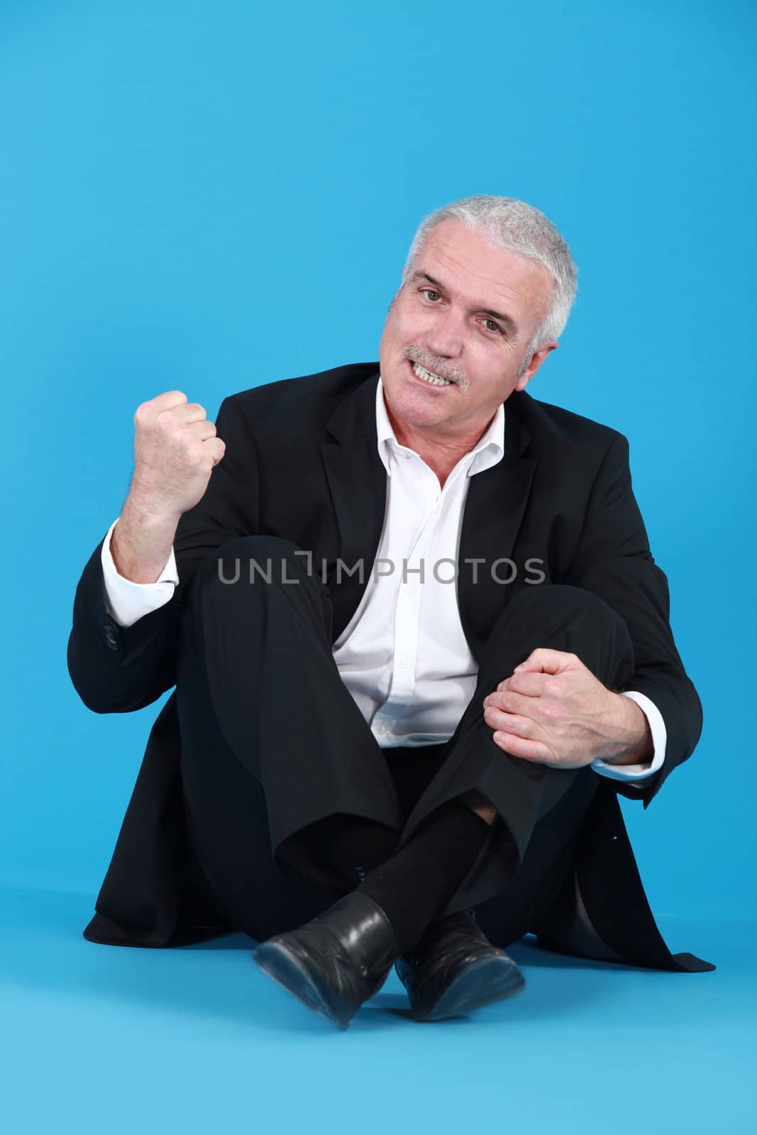 An angry man sitting cross-legged