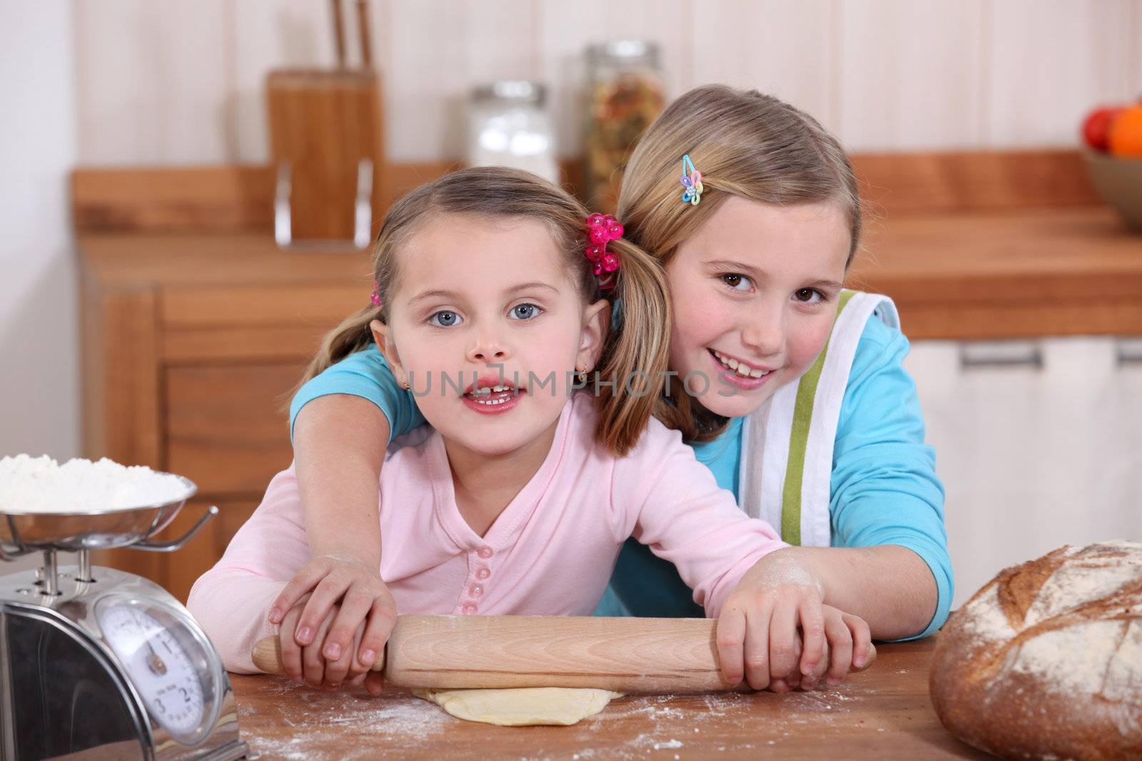 Sisters baking in the kitchen by phovoir