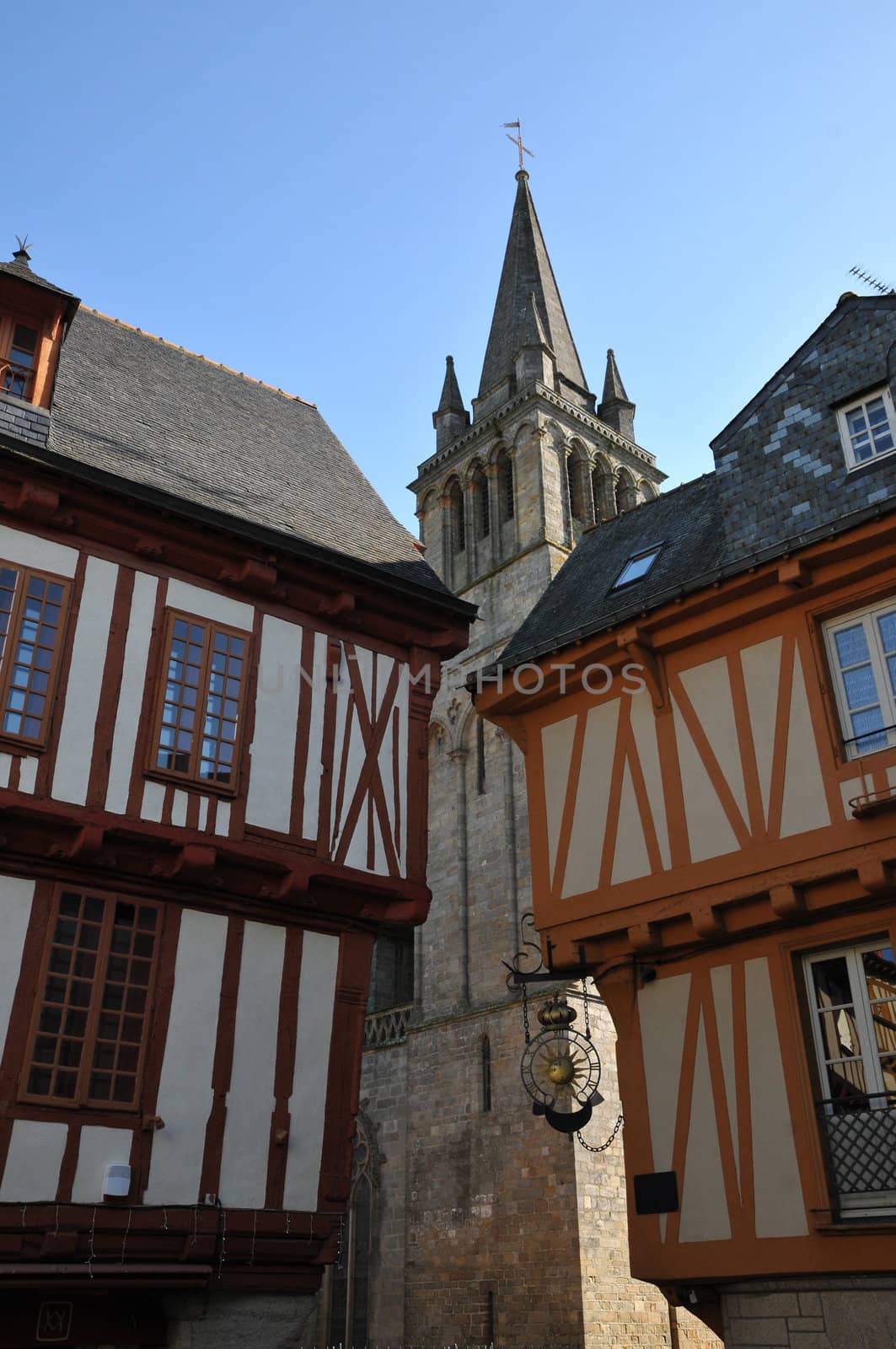 Two Old half-timbered Houses with a Church inside Vannes Streets with a blue sky