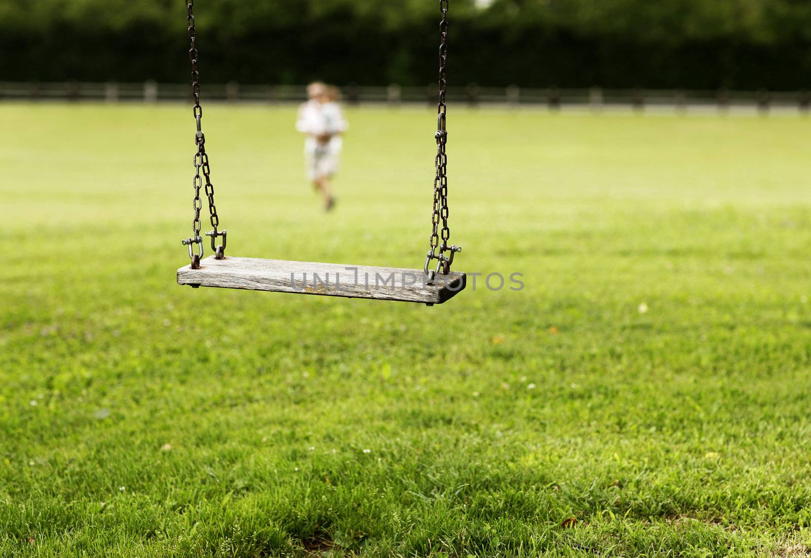 swing hanging in garden, child on background by stokkete