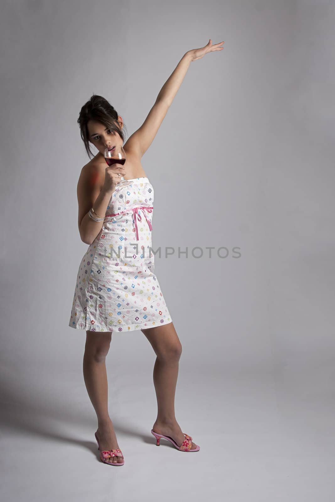 Girl dancing with a glass of red wine