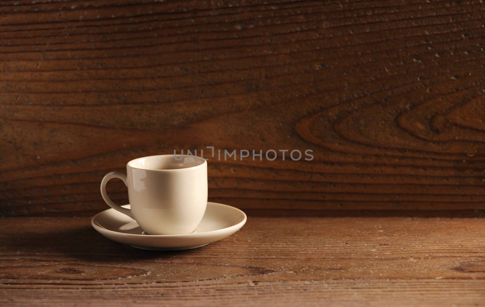 cup of coffee on the wooden table by stokkete