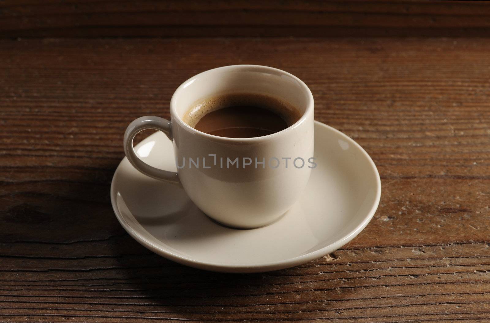cup of coffee on the wooden table by stokkete