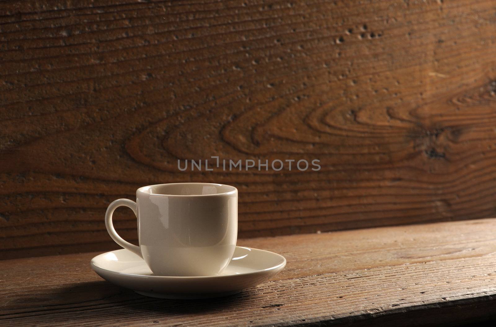 cup of coffee on the wooden table by stokkete