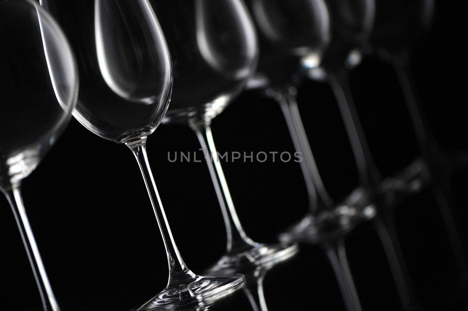 wine glass on black background  by stokkete