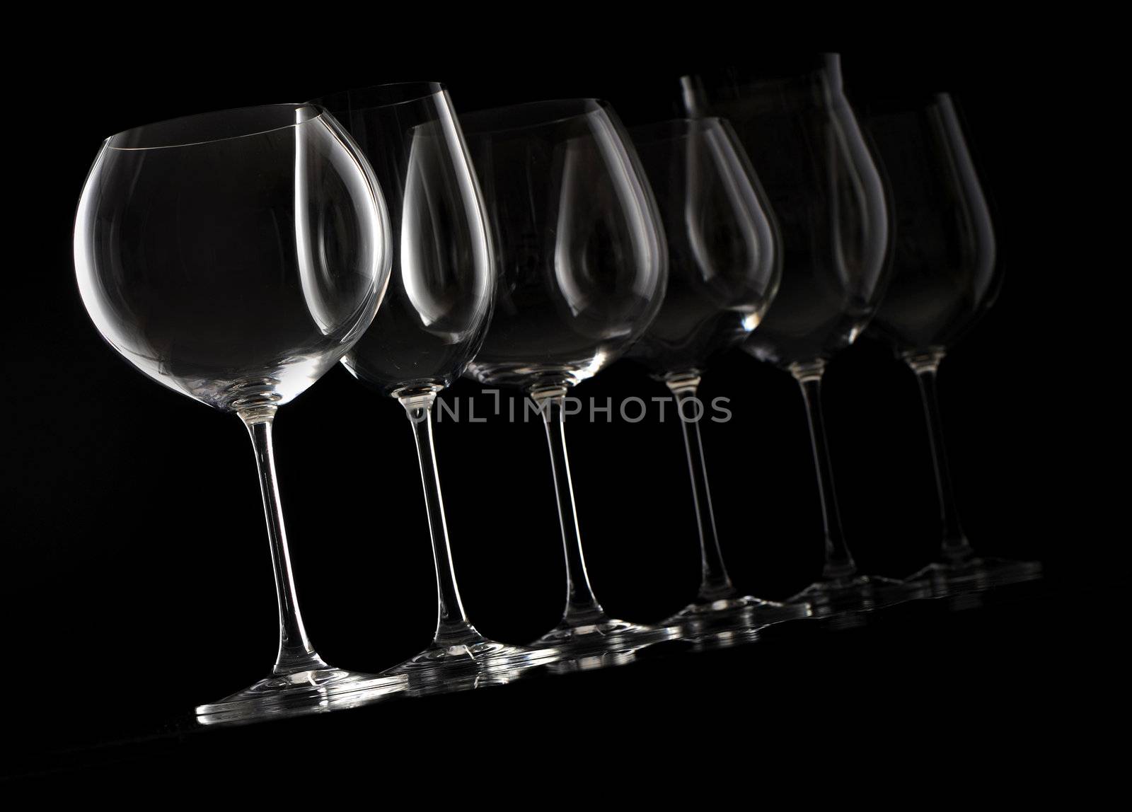 wine glass on black background  by stokkete