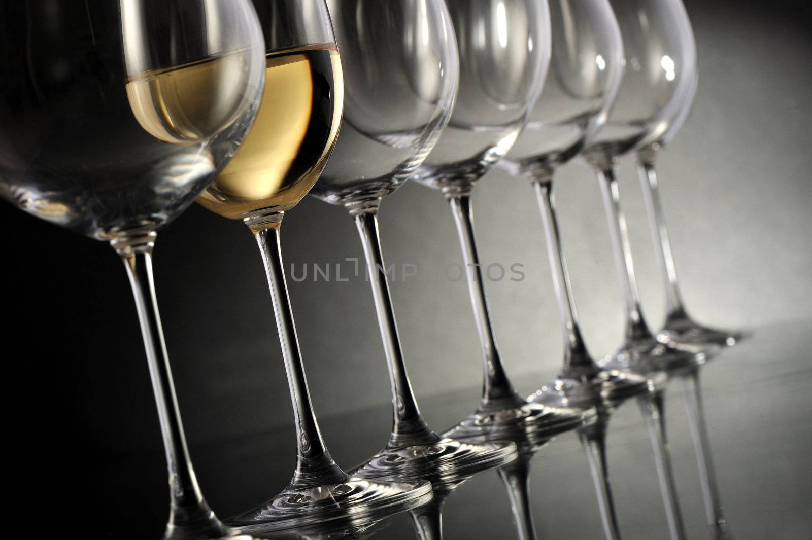 wine glasses group on dark background by stokkete