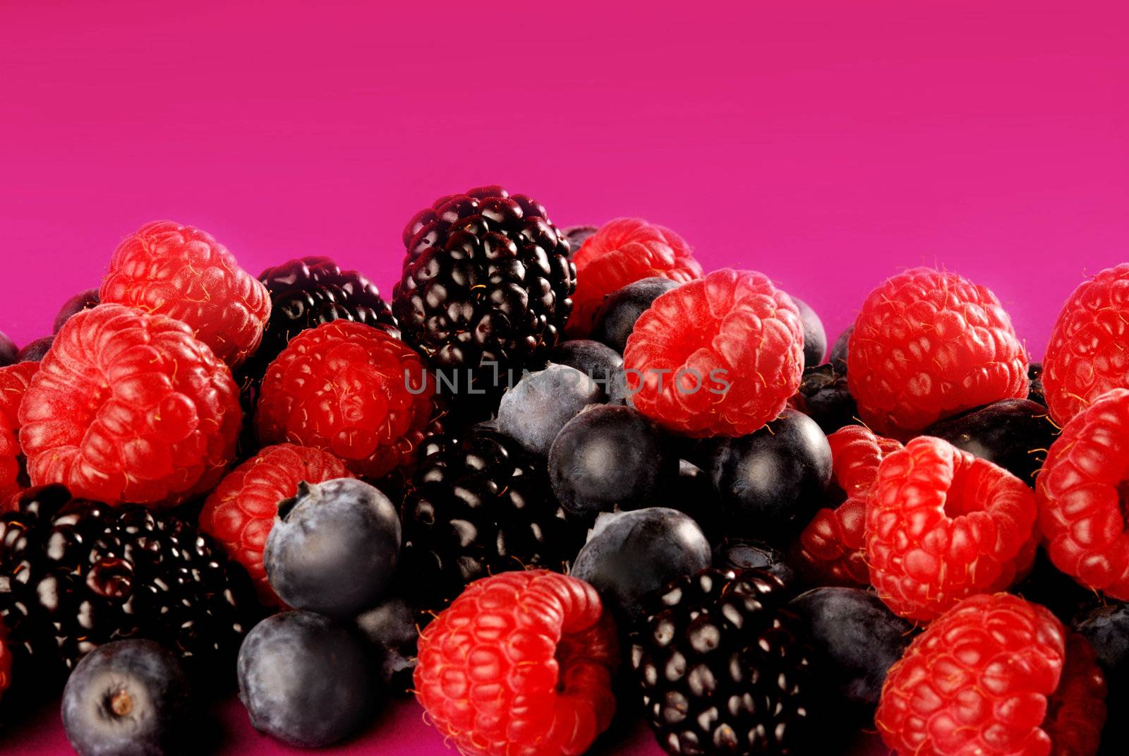 raspberries and blueberries by stokkete