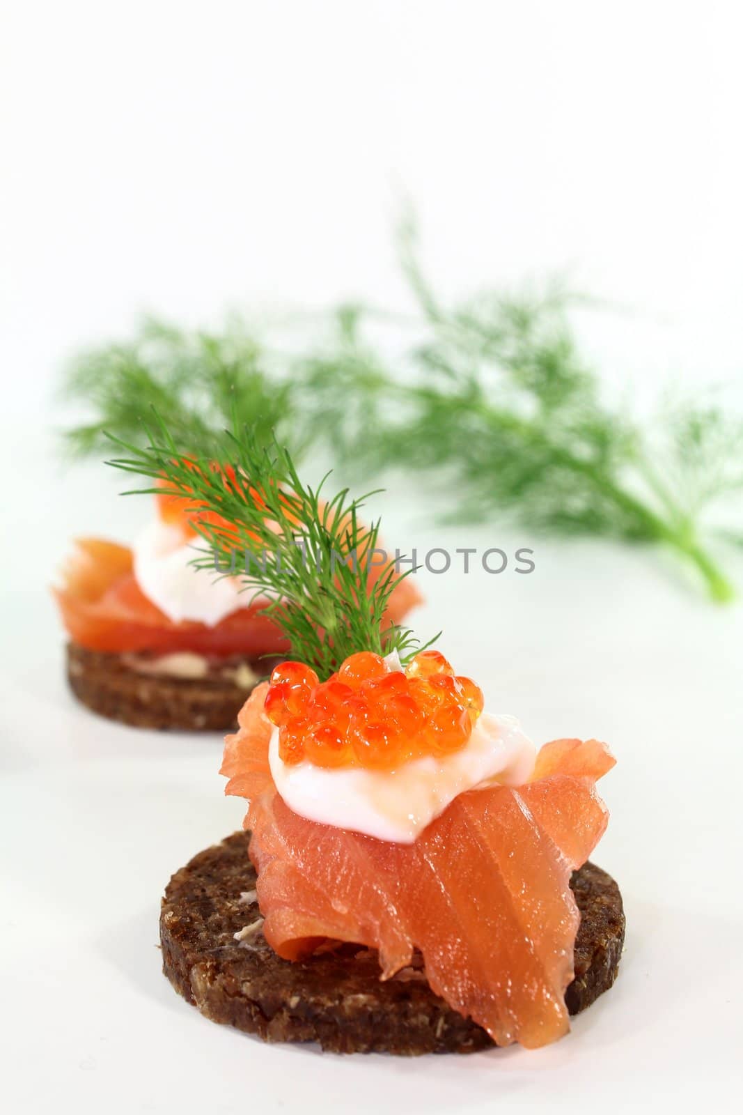 Canapes with smoked salmon, caviar and dill