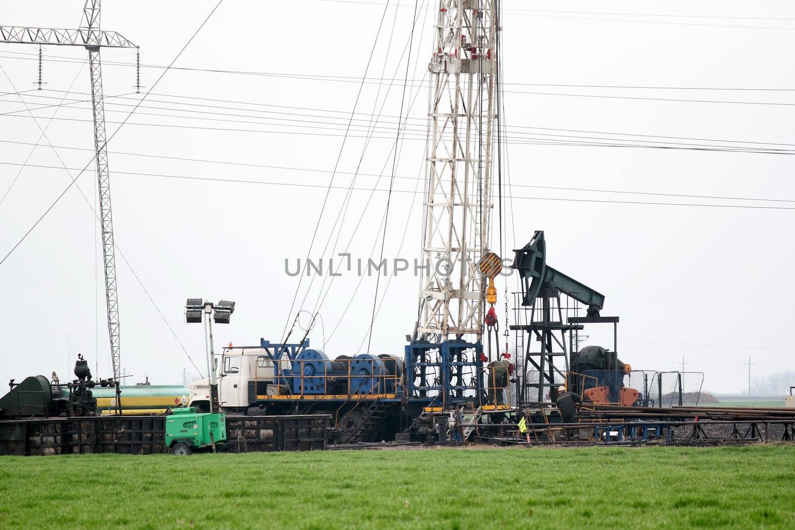 heavy industry oilfield with rig and pump jack