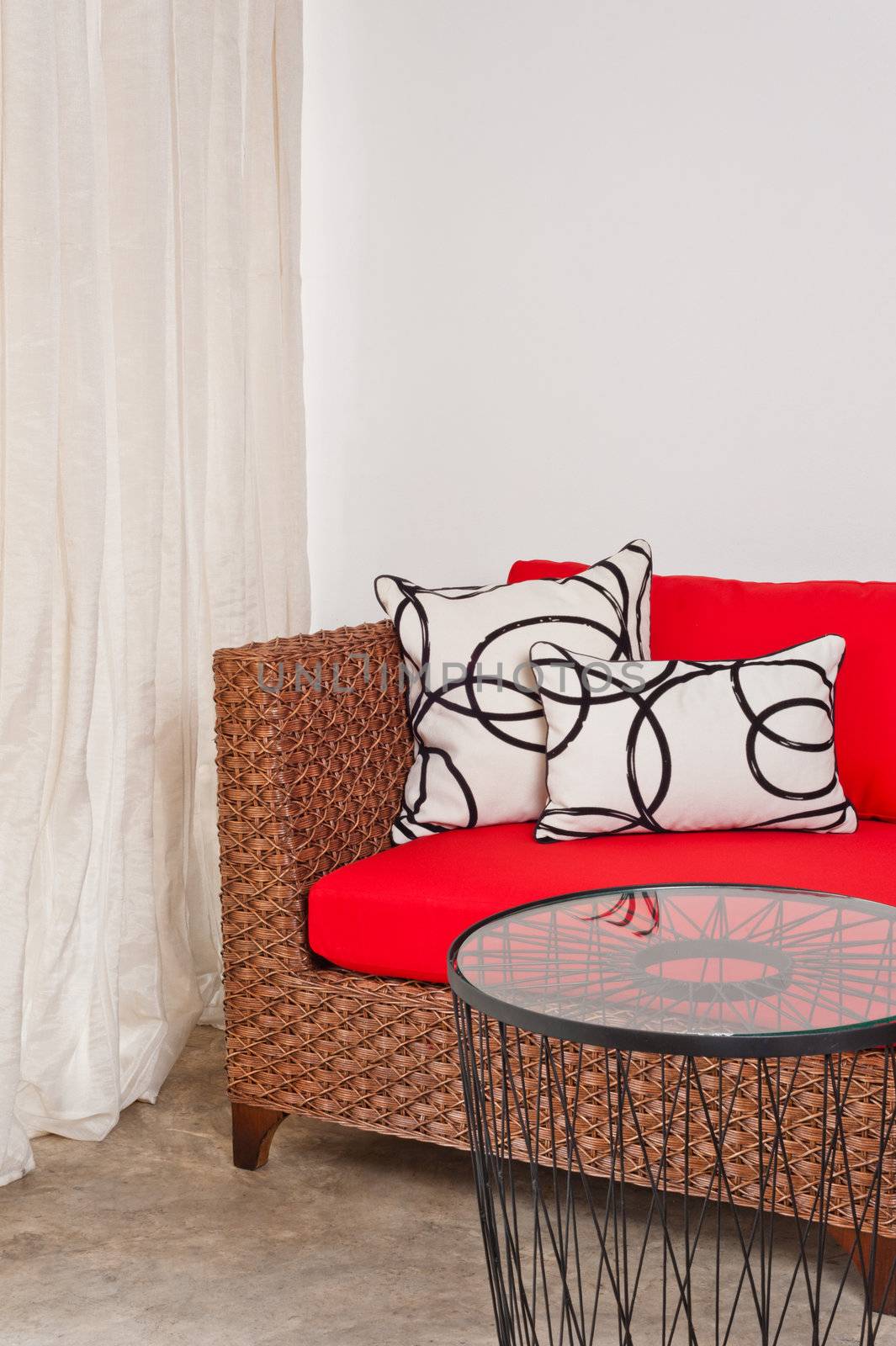 red brown basketwork sofa in interior setting 