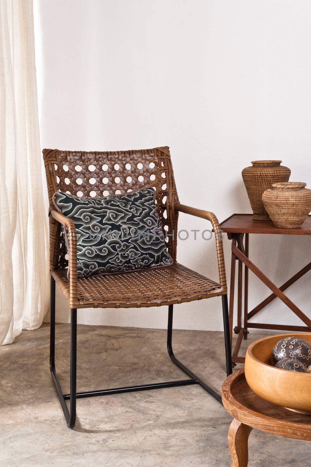Brown rattan Chair in interior setting by 3523Studio