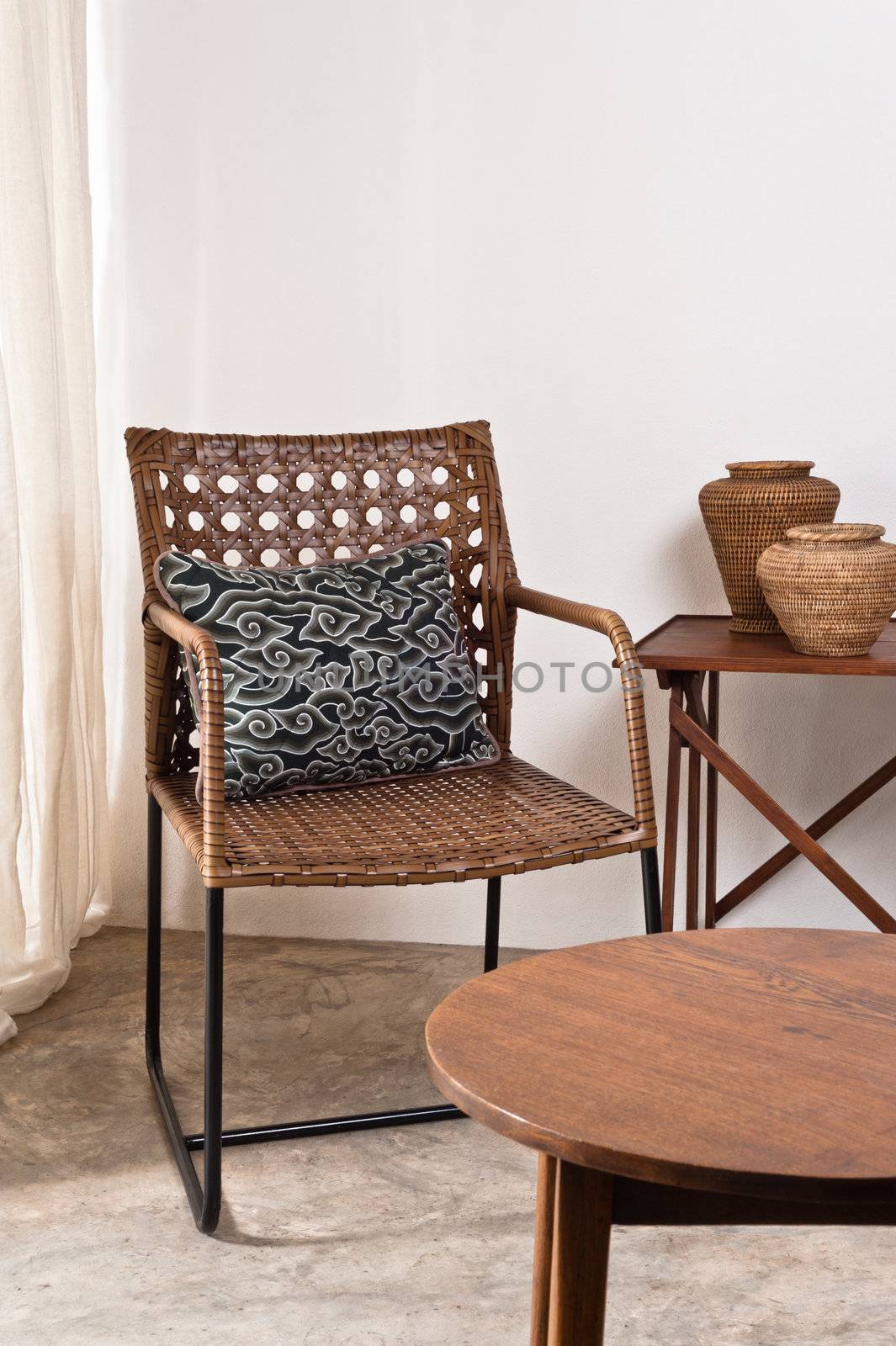 Brown rattan Chair in interior setting by 3523Studio