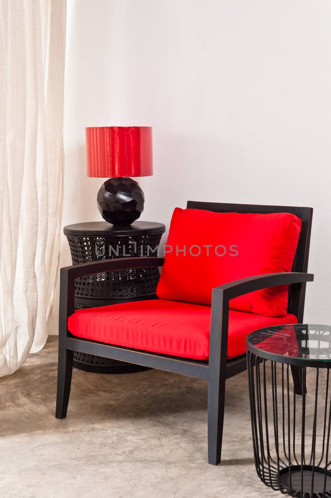 Black red Chair and side table in a bright setting