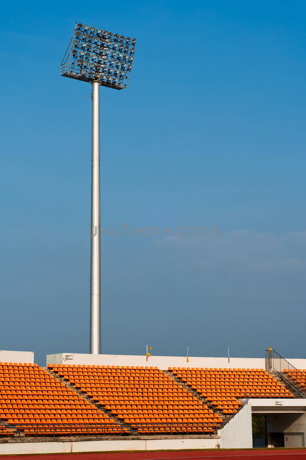 Contemporary stadium Orange seat light and track with blue sky