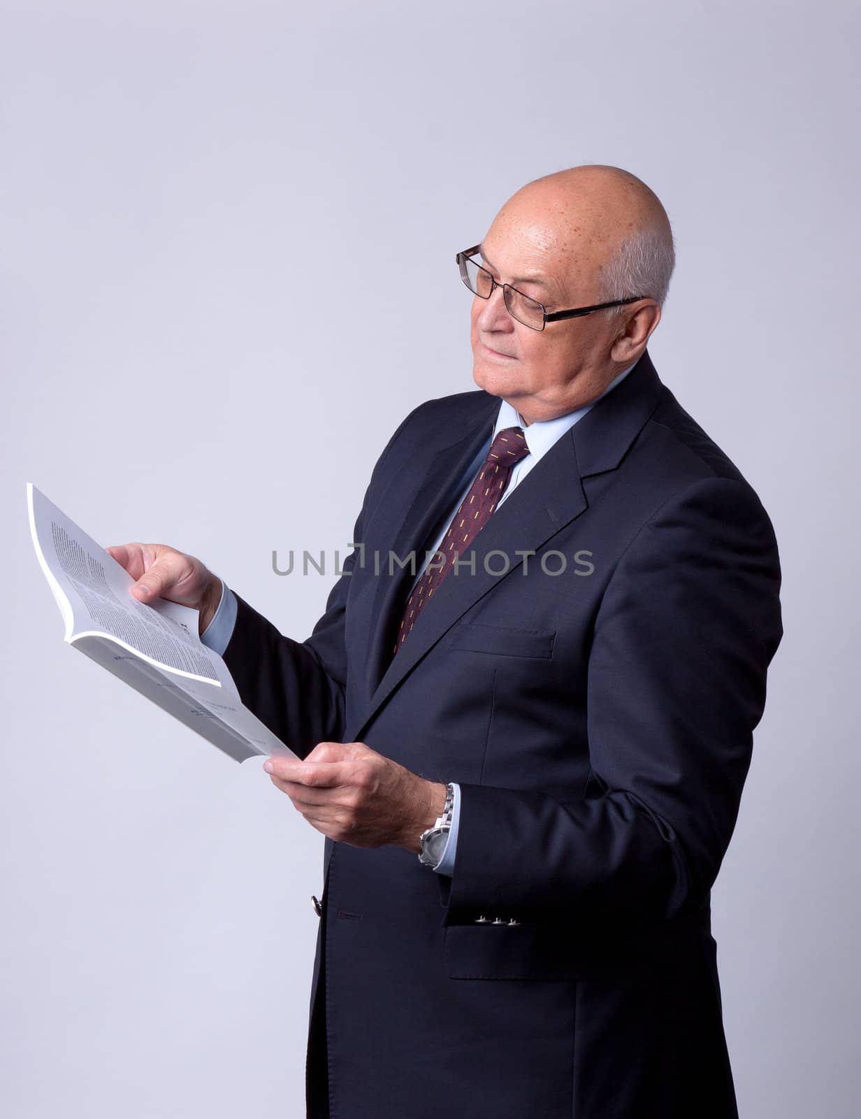 portrait of a successful senior man with book by Discovod