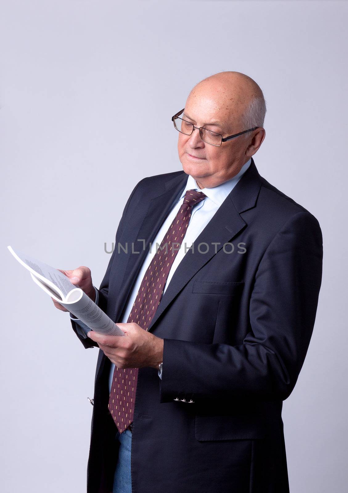 portrait of a successful senior man with book by Discovod