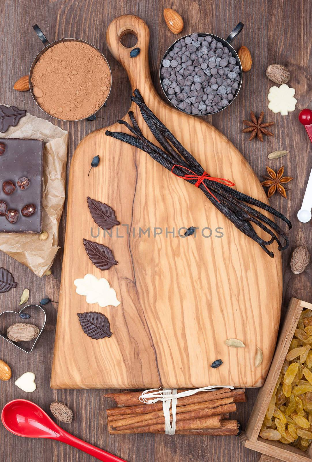 Wooden board with prepared to sweet chocolate baking ingredients