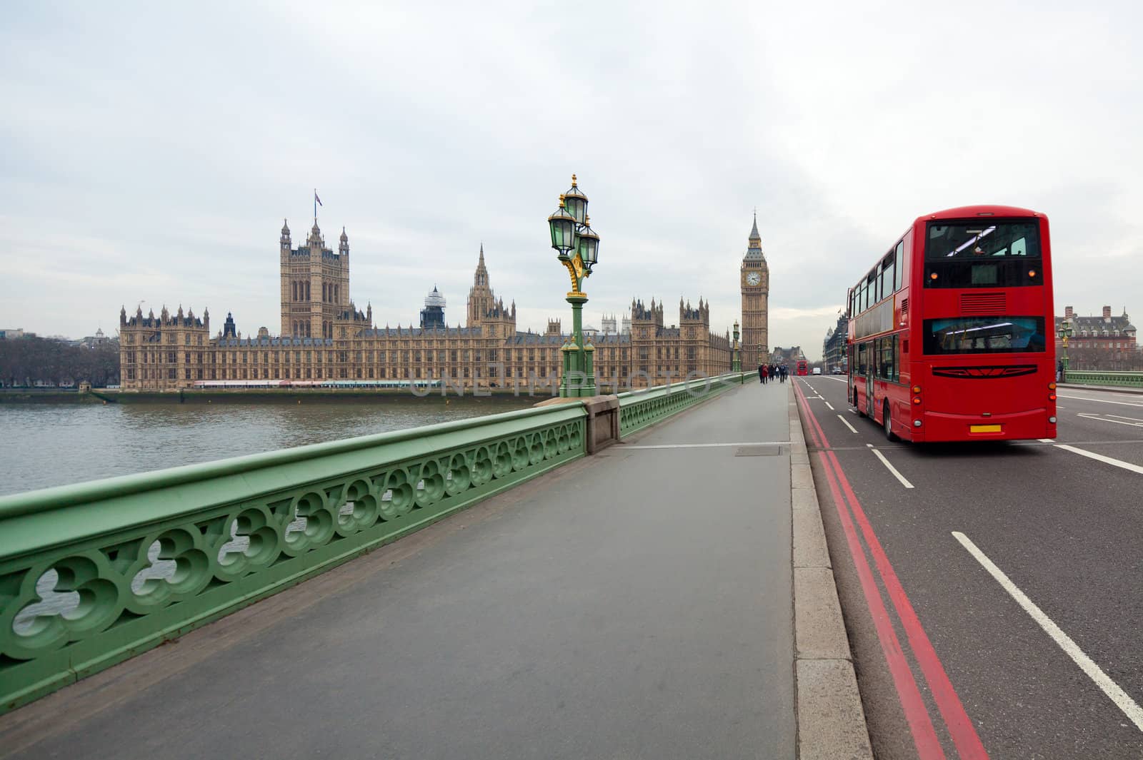 Westminster Bridge with views of the British Parliament and Big Ben. London red double decker bus passes nearby