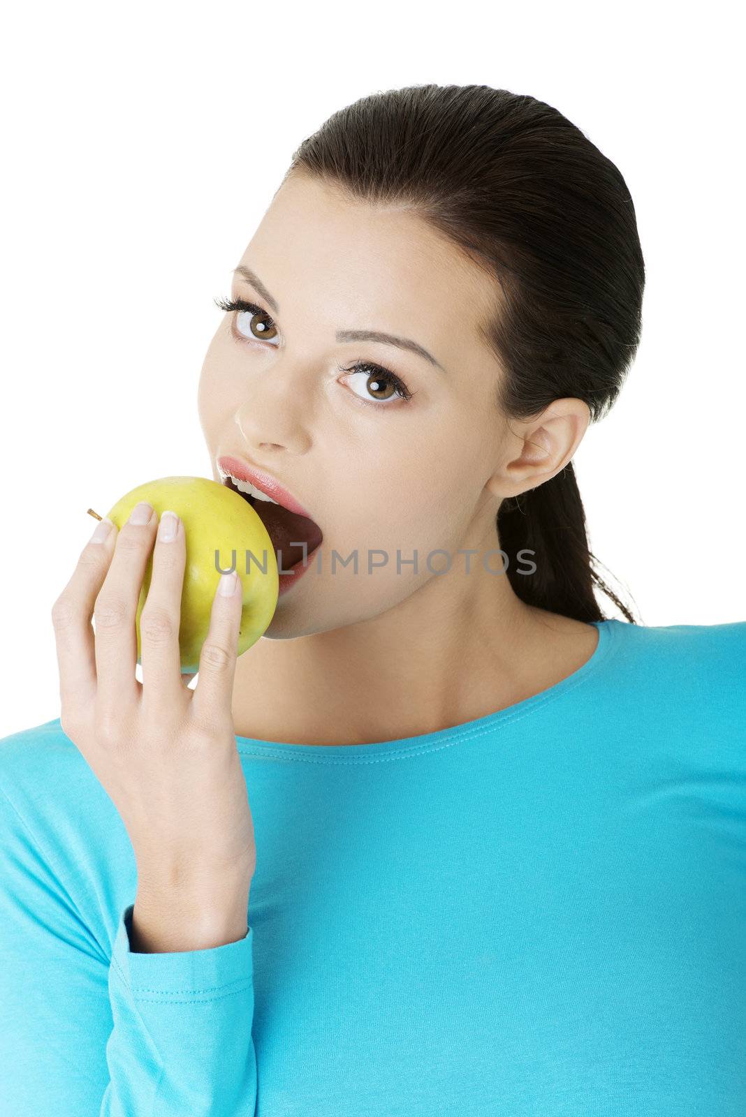 Attractive young woman eating green apple. Isolated on white background