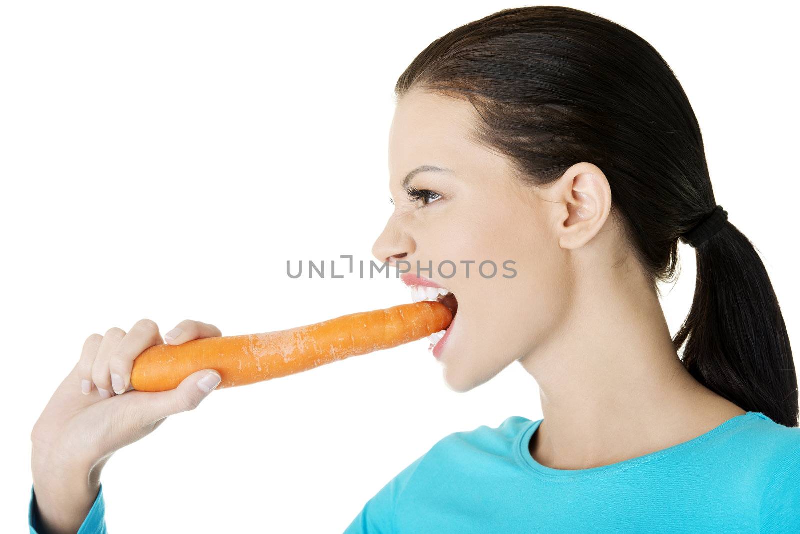 Fit young happy beautiful woman with carrot, isolated on white