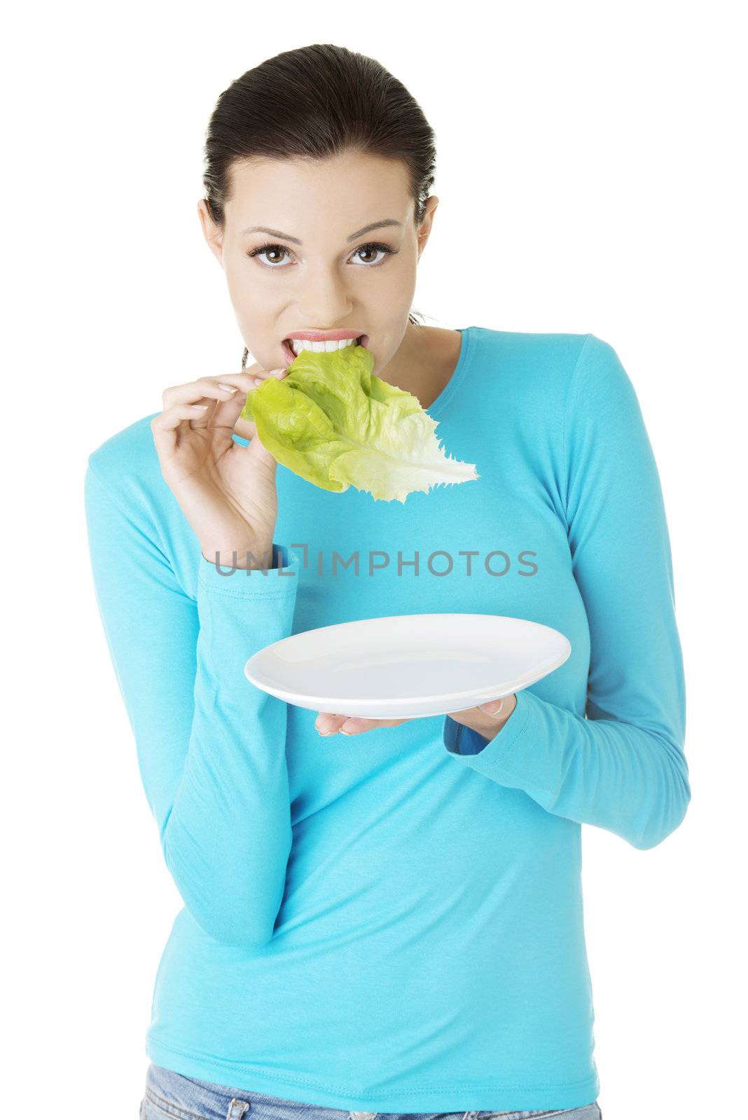 Fit young beautiful woman eating salat by BDS