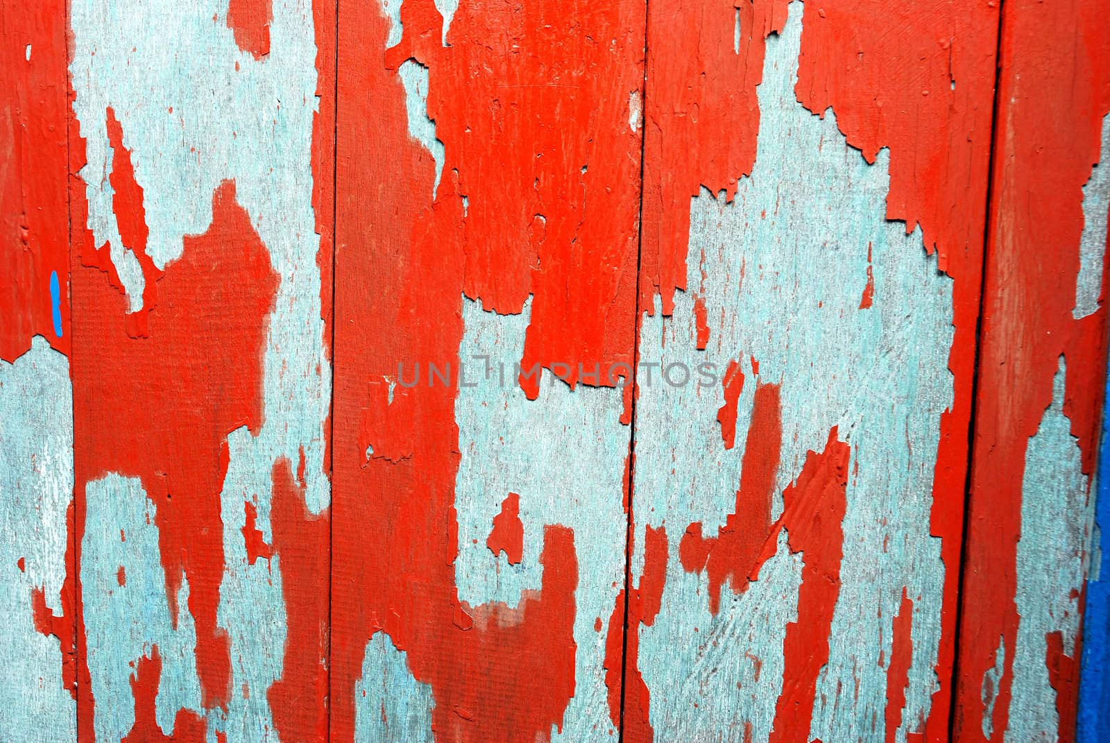 detailed of  texture and pattern at old wooden boards with paint that was peeling and faded
