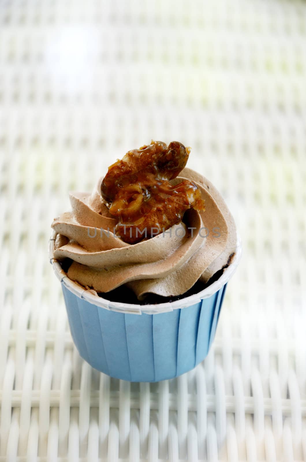 Cupcake with caramel walnut on table