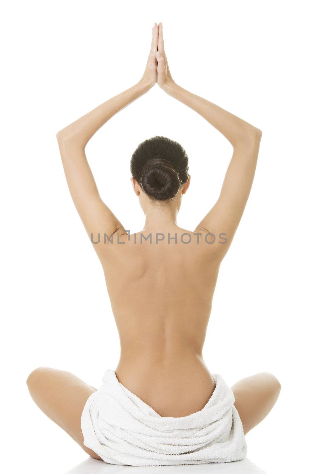 Young beautiful nude woman with towel practicing zoga , isolated on white