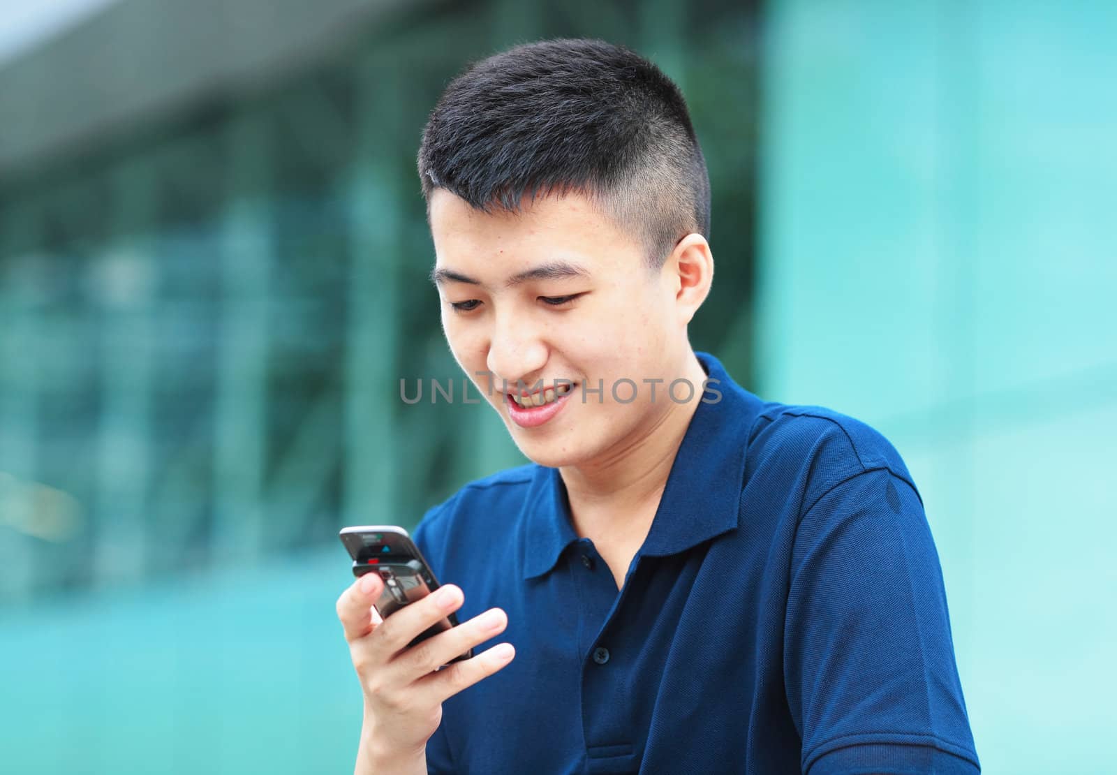 Man typing message on phone by leungchopan