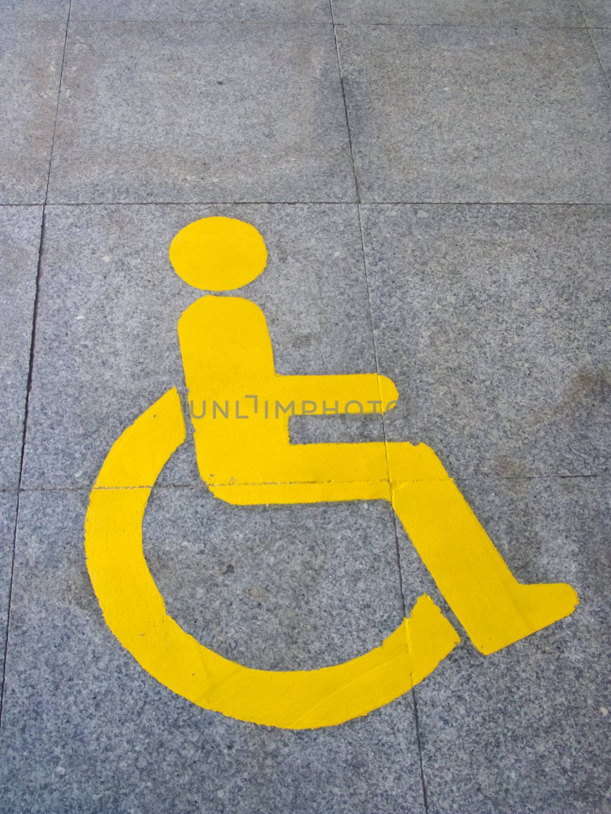 Yellow handicapped sign of floor tile