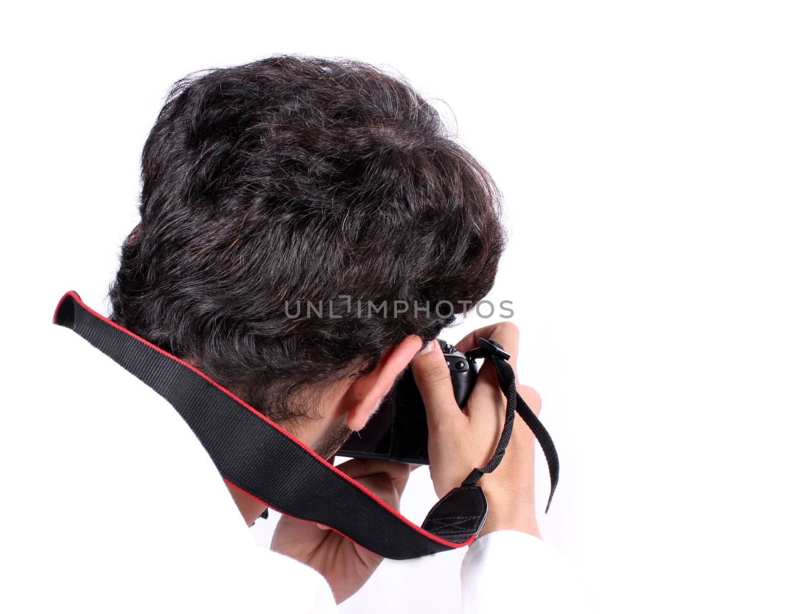 A rear view of a photographer in action, on white studio background.