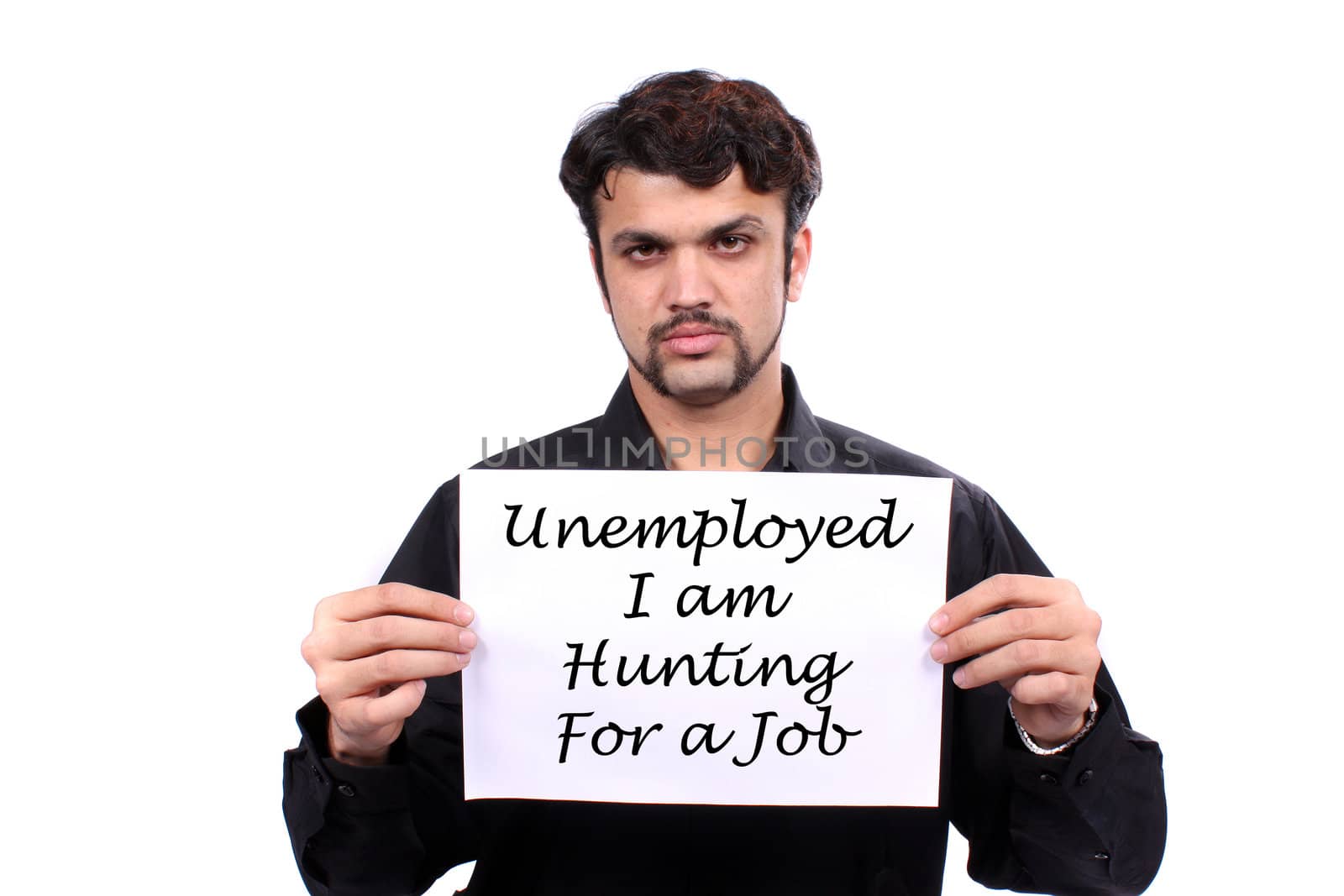 An unemployed Indian man holding a 'Looking for Job' banner, on white studio background.