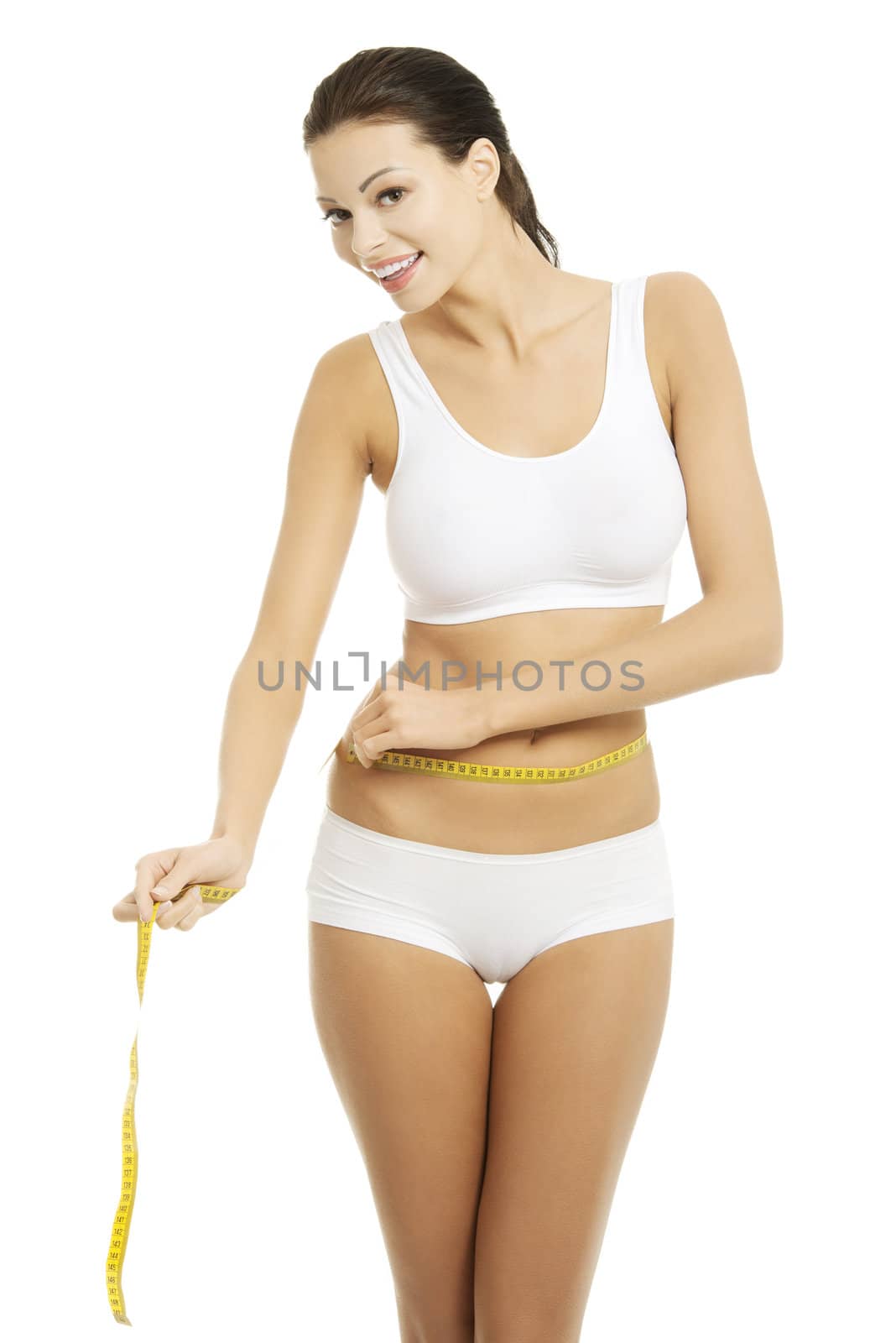 Happy young woman measuring her waist , isolated on white