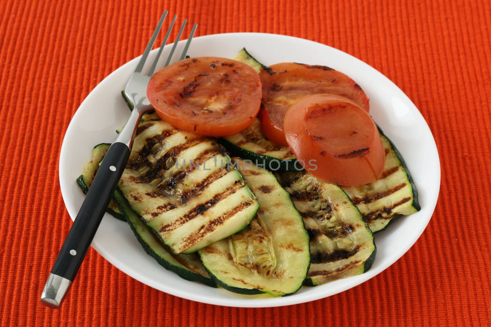 grilled vegetables on the plate by nataliamylova