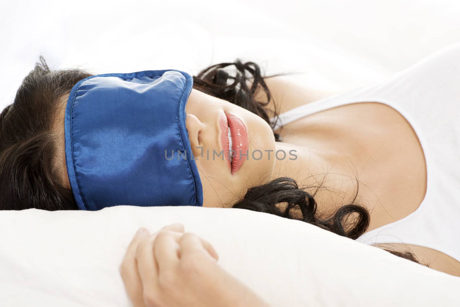 Beautiful happy young woman resting in bed